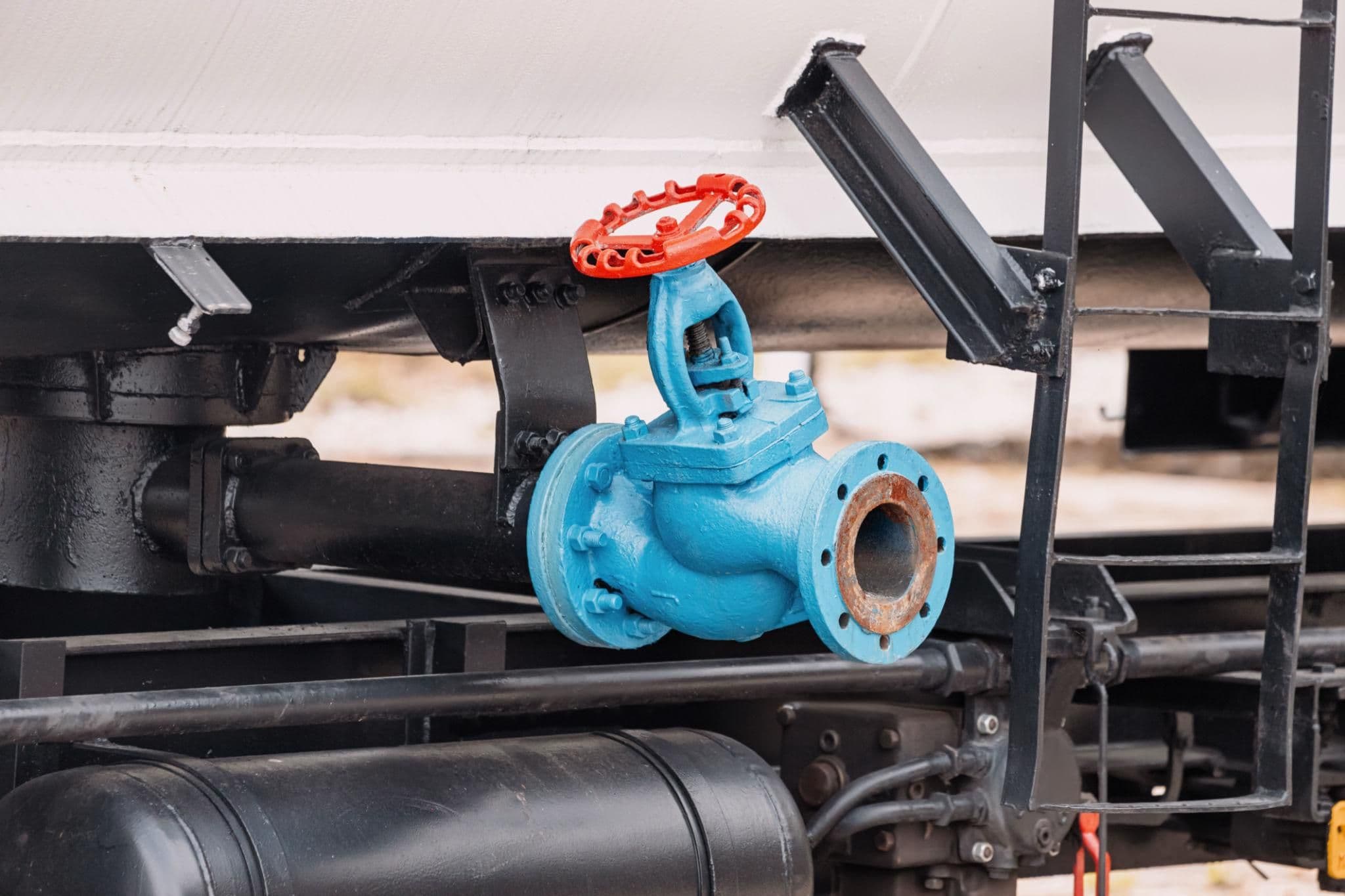 Industrial gate valves guide featuring a blue valve with red handwheel on industrial pipework.