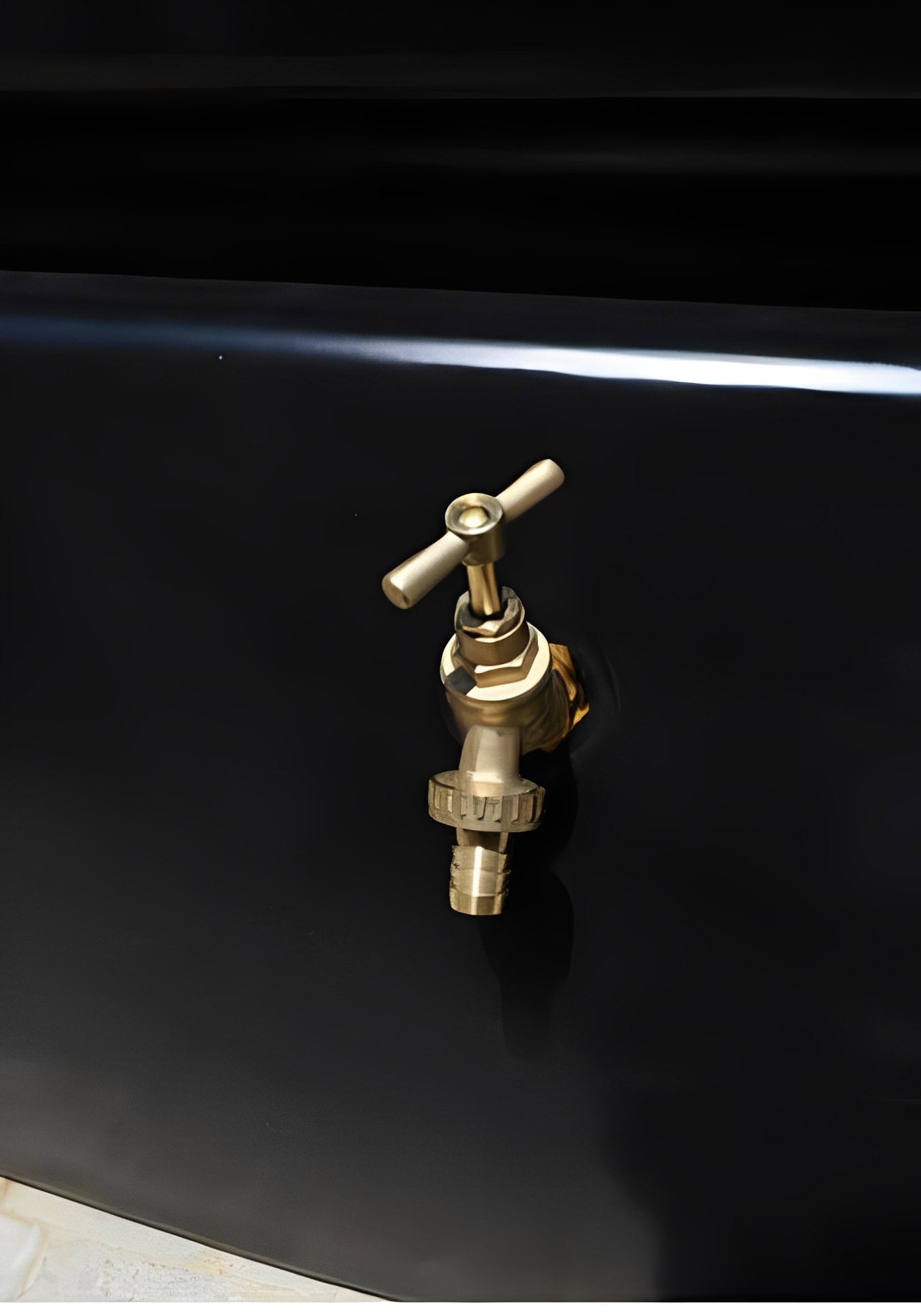 Slimline Water Tank 1500 Litres Black with a brass tap and valve for water access.
