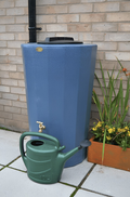 Midi Metro 185L Water Butt - Blue Marble Effect Tank next to a green watering can