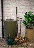 Midi Metro 185L Water Butt - Green Marble Effect alongside gardening tools and a plant.