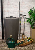Millstone Midi Metro 185L Water Butt - Millstone Effect with garden tools and plants