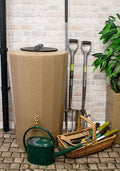 Midi Metro 185L Water Butt - Sandstone Effect Slim Design beside gardening tools in stylish outdoor space.
