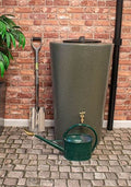 City Just Water 210L Water Butt - Green Marble Effect next to a watering can and shovel in a garden setting.