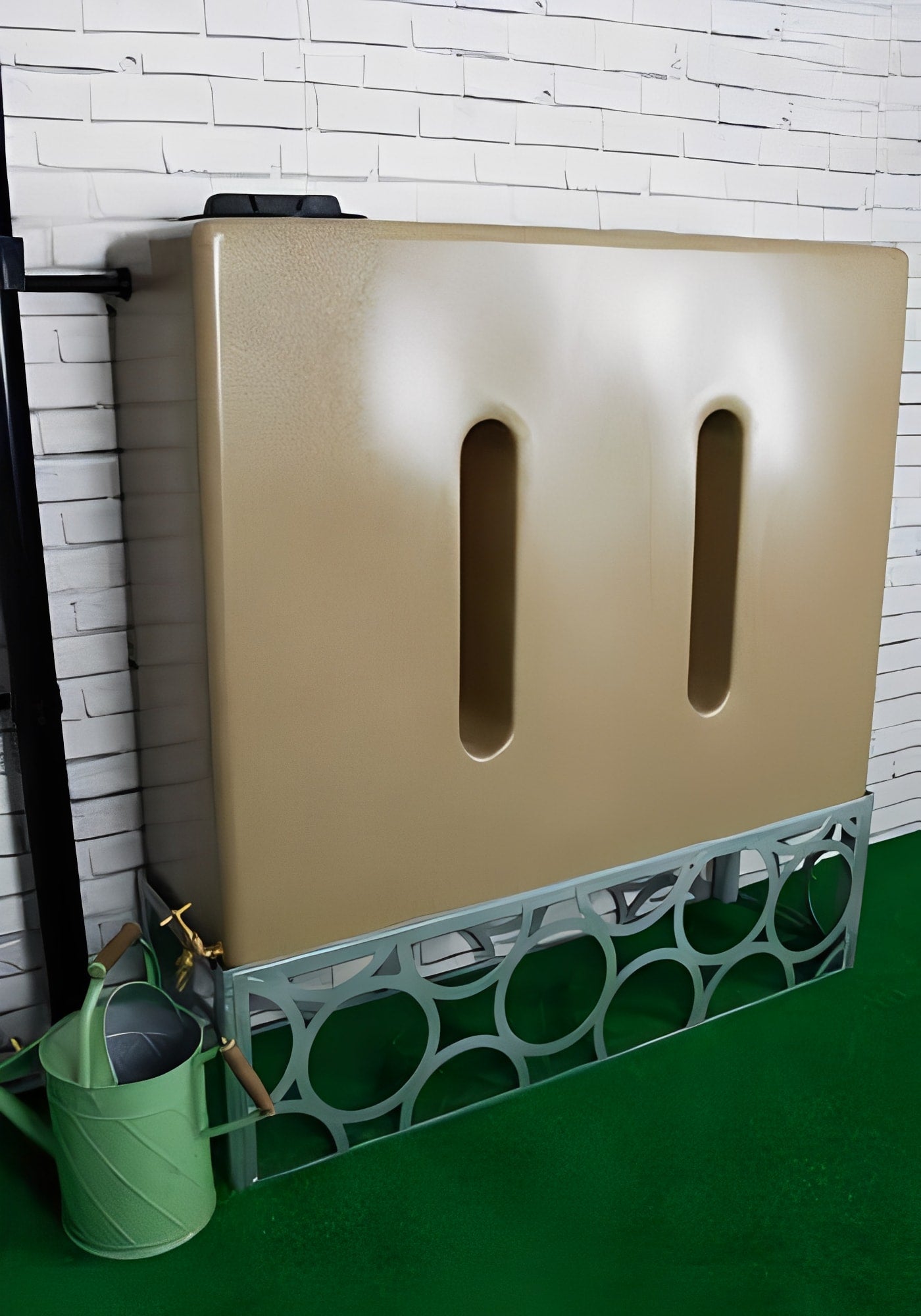 500 Litre Water Tank V1 - Sandstone installed in a compact outdoor space beside a watering can.