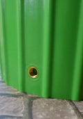 Close-up of the gold fitting on the Cosmo 200L Water Butt Planter - Apple Green Decorative MDPE surface.