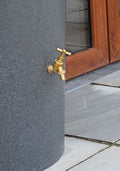 Black Big City Water Butt Planter - 380L Capacity featuring a brass tap on a stylish grey barrel.