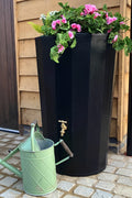 Black Midi Metropolitan Water Butt Planter - 165L Black with flowers and watering can