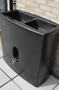 Black Oasis 375L Water Butt Planter - Black Cylindrical MDPE displayed against a brick wall.