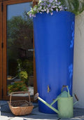 Blue Big City Water Butt Planter - 380L Blue Capacity with flowers, watering can, and basket.