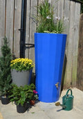 Metropolitan 255L Water Butt Planter - Blue Decorative Tank with plants and flowers in a garden setting.