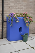 Blue Oasis 375 Litre Water Butt Planter - Bright Blue MDPE with flowers and watering can.