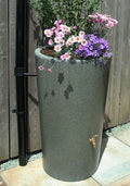 Green Marble City Water Butt Planter - 180L Stone Effect Tank with flowers and water outlet.