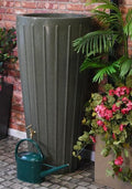 Cosmo 200L Water Butt Planter - Green Marble Effect beside flowering plants and watering can.