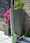 Metropolitan 255L Water Butt Planter - Green Marble Effect with colorful flowers and a green watering can