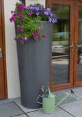 Millstone Big City Water Butt Planter - 380L Capacity with flowers and watering can