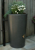 Millstone City Water Butt Planter - 180L Stone Effect Tank with flowers, stylish garden water storage.