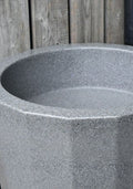 Millstone Metropolitan 255L Water Butt Planter - Stone Effect showcasing its stone design and large storage capacity.