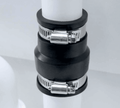 PQ135-115 Black PVC Adaptor Coupling 113mm-135mm x 107mm-115mm connecting pipes in a drainage system.