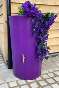 Purple Midi Metropolitan 165L Water Butt Planter featuring purple flowers for a stylish garden decoration.