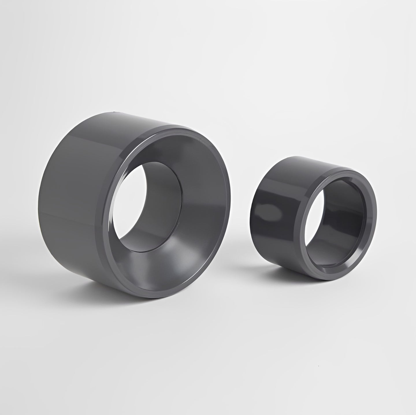 PVC Metric Plain Reducing Bush - WRAS Approved Potable Water, showing two sizes of gray reducing bushes.