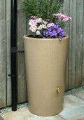 Sandstone City 180L Water Butt Planter - Sandstone Effect with flowers and rainwater harvesting feature.