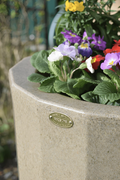 Midi Metropolitan 165L Water Butt Planter - Sandstone with colorful flowers and natural stone-effect finish.