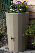 Midi Metropolitan 165L Water Butt Planter - Sandstone featuring colorful flowers and a water tap.
