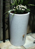 White Marble City Water Butt Planter - 180L Decorative Tank with flowers and gold tap in garden setting.