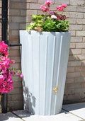 Cosmo White Marble Water Butt Planter - 200L Decorative Tank with colorful flowers in a stylish garden setting.